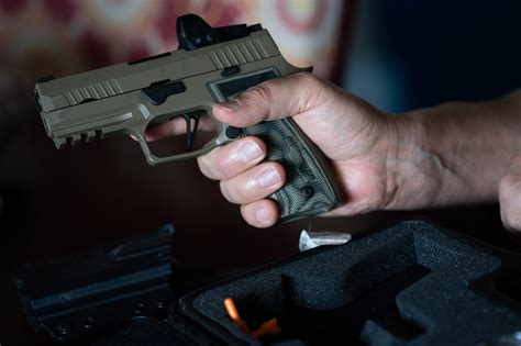 how-long-to-become-good-at-shooting-sig-p320 person shooting Sig P320 handgun