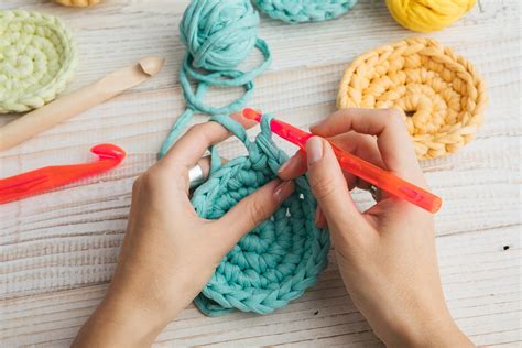 person crocheting yarn crafts