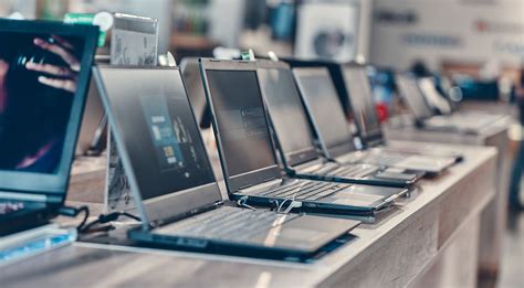 person comparing laptops in store