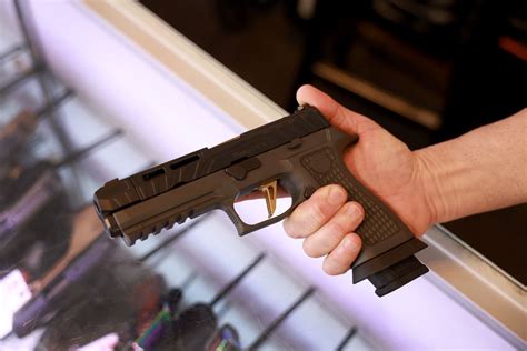 person handling Sig P320 firearm