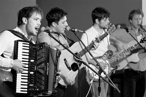 how-long-to-learn-mumford-and-sons-song-guitar person playing guitar Mumford and Sons song