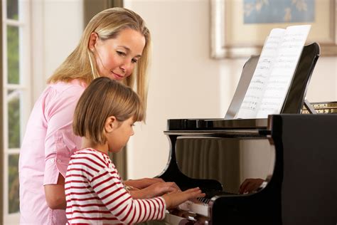 child learning piano lessons
