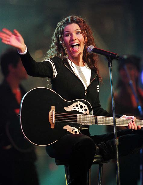 how-long-to-learn-shania-twain-greatest-hits person playing guitar Shania Twain songs
