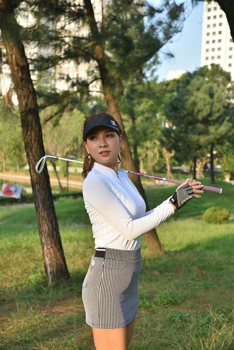 female golfer practicing swing