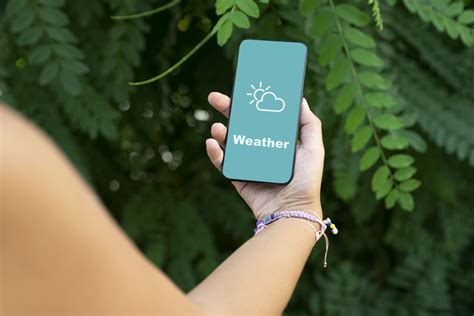 how-long-to-prepare-for-sudden-nyc-weather-changes person checking weather app NYC