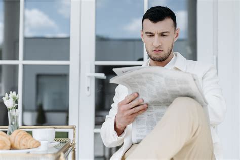 person reading newspaper columns