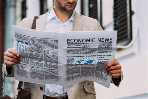 person reading newspaper column