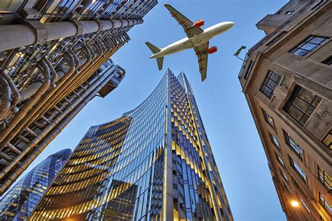 airplane flying over city skyline